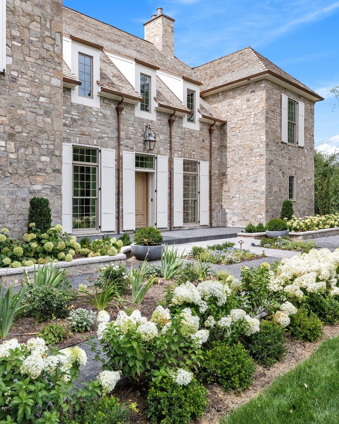 Stone exterior of a custom home shared by North Star Builders